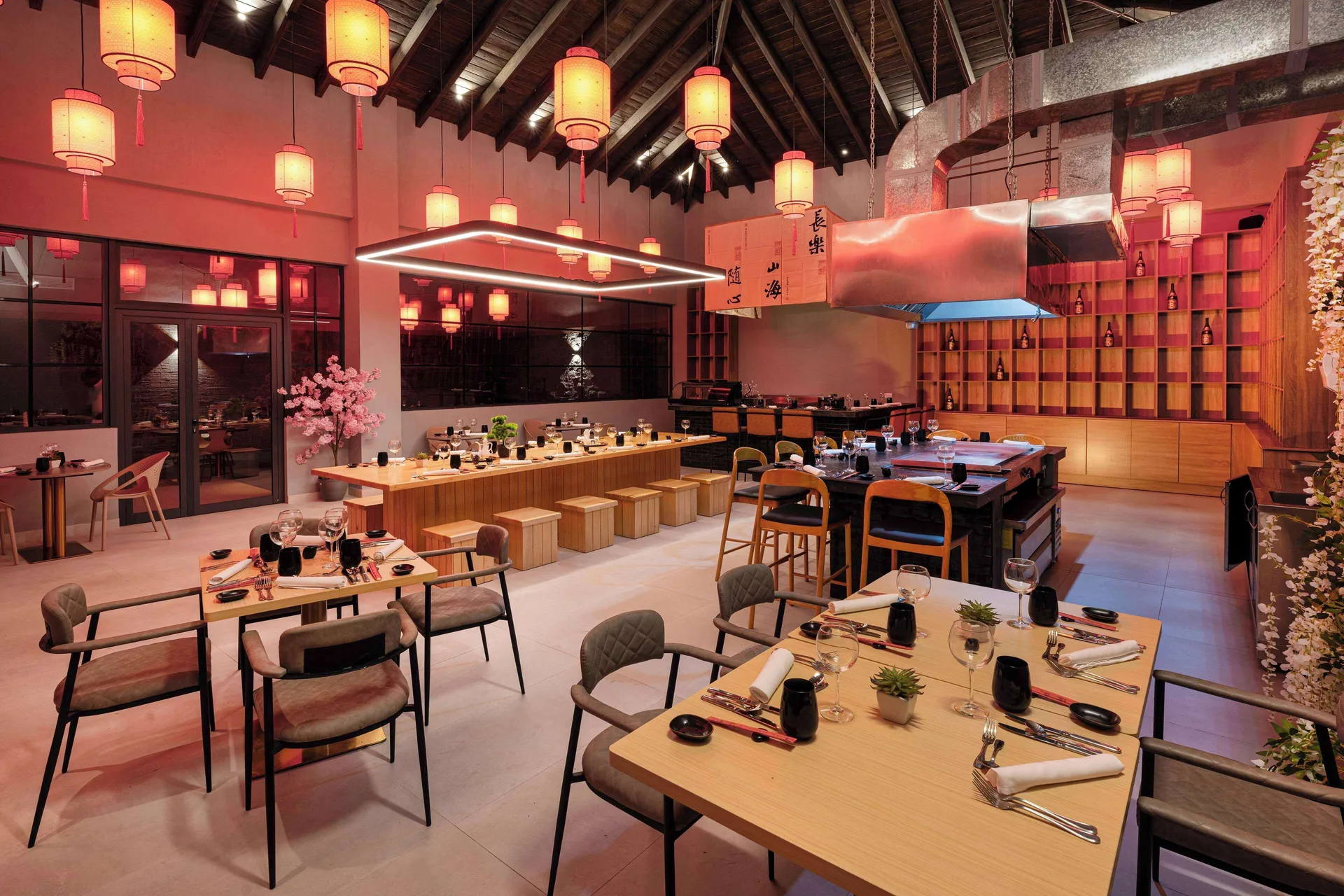 Lantern-lit dining room with set tables and counter seating at Viva Miches.