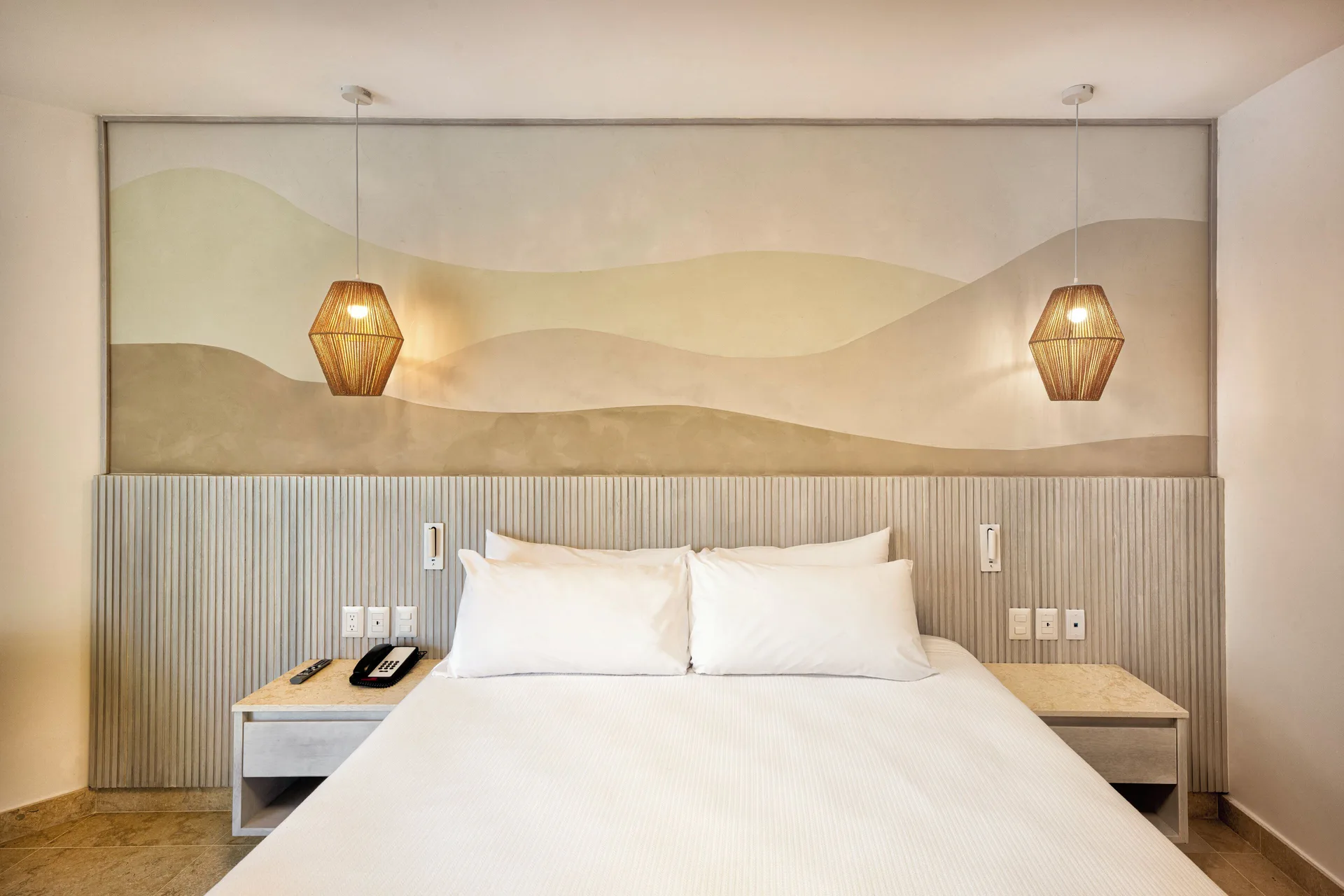 Splash Room king bed with symmetrical pendant lights at Viva Miches.