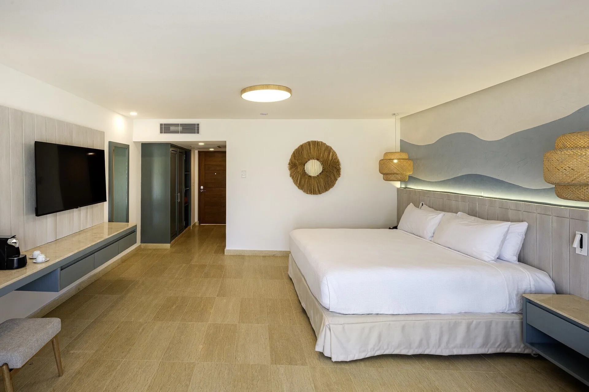 Splash Room with king bed, woven mirror, and mounted TV at Viva Miches.