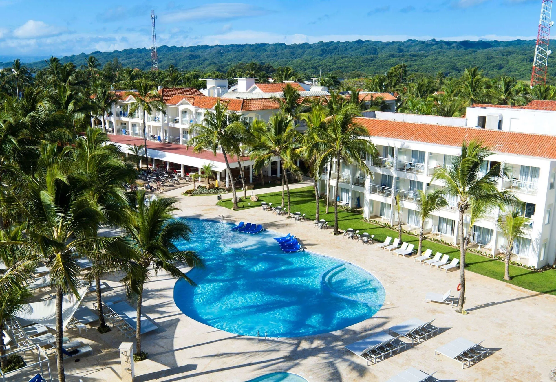 Aerial view of pool, palms, and resort buildings at Viva Tangerine.