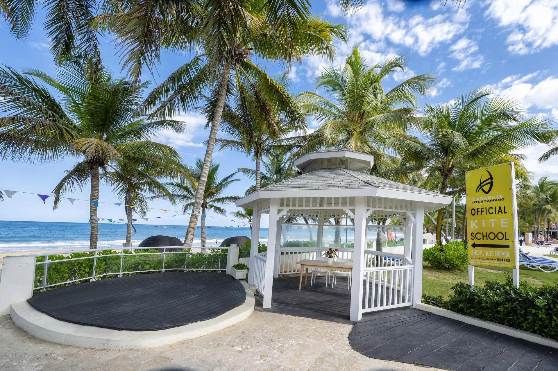 Beachside gazebo and kite school sign among palms at Viva Tangerine.