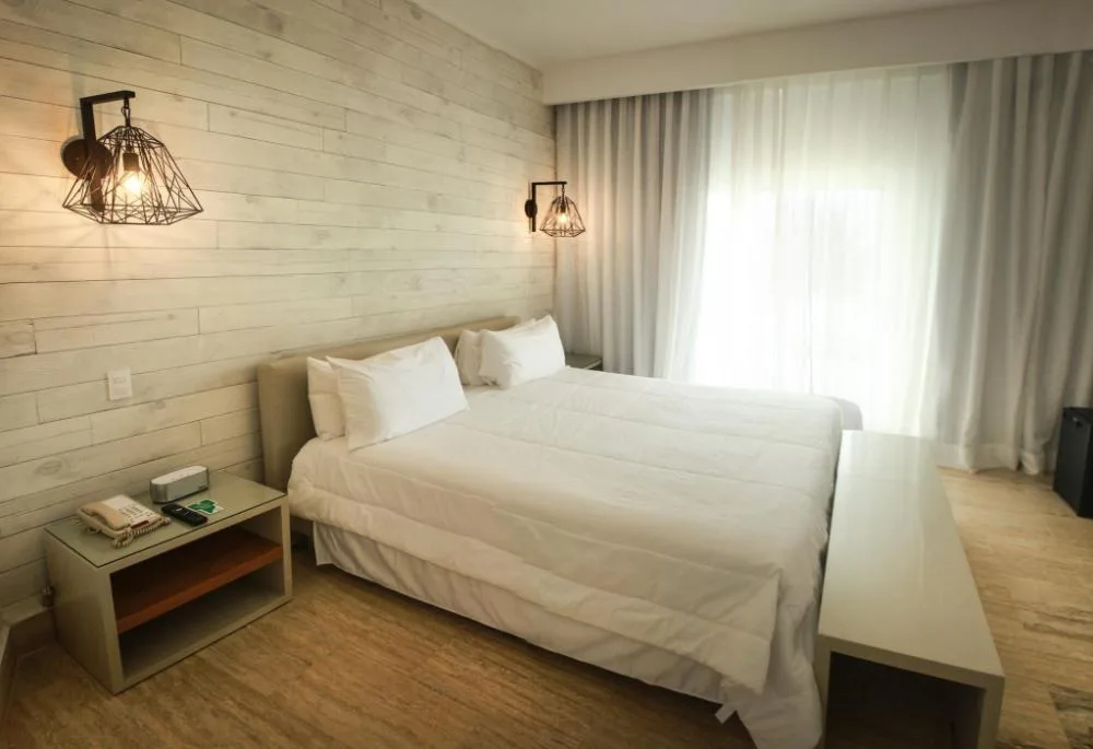 Accessible non-smoking guest room with two beds and wall lights at Viva Tangerine.