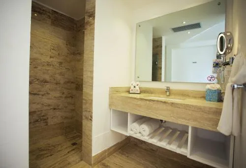 Accessible non-smoking room bathroom with walk-in shower and vanity at Viva Tangerine.