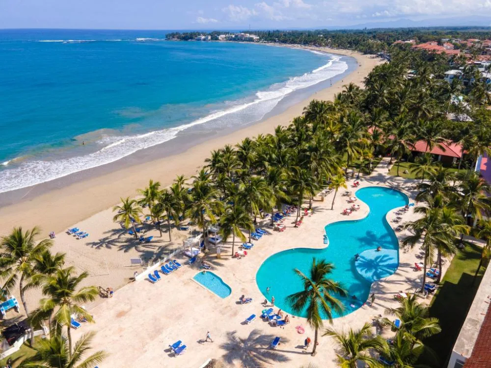 Aerial view of the beach, palms, and pool area at Viva Tangerine.
