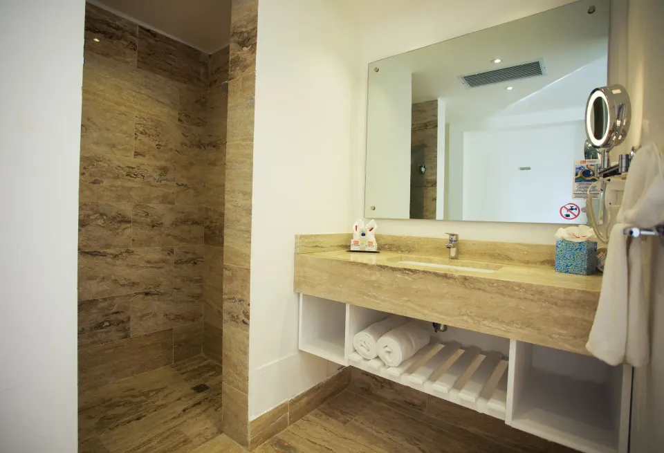 Superior Ocean bathroom with stone shower and vanity at Viva Tangerine.