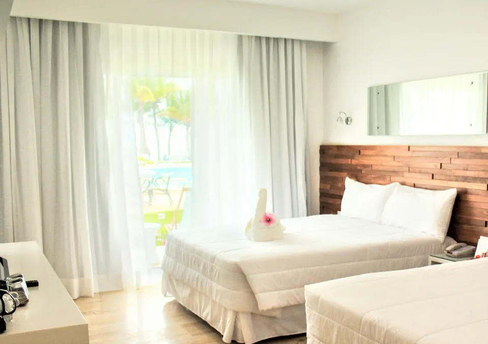 Superior Ocean room with two beds and balcony curtains at Viva Tangerine.