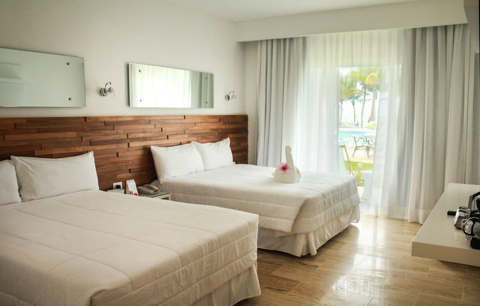 Superior Ocean room with two beds, mirrors, and balcony at Viva Tangerine.
