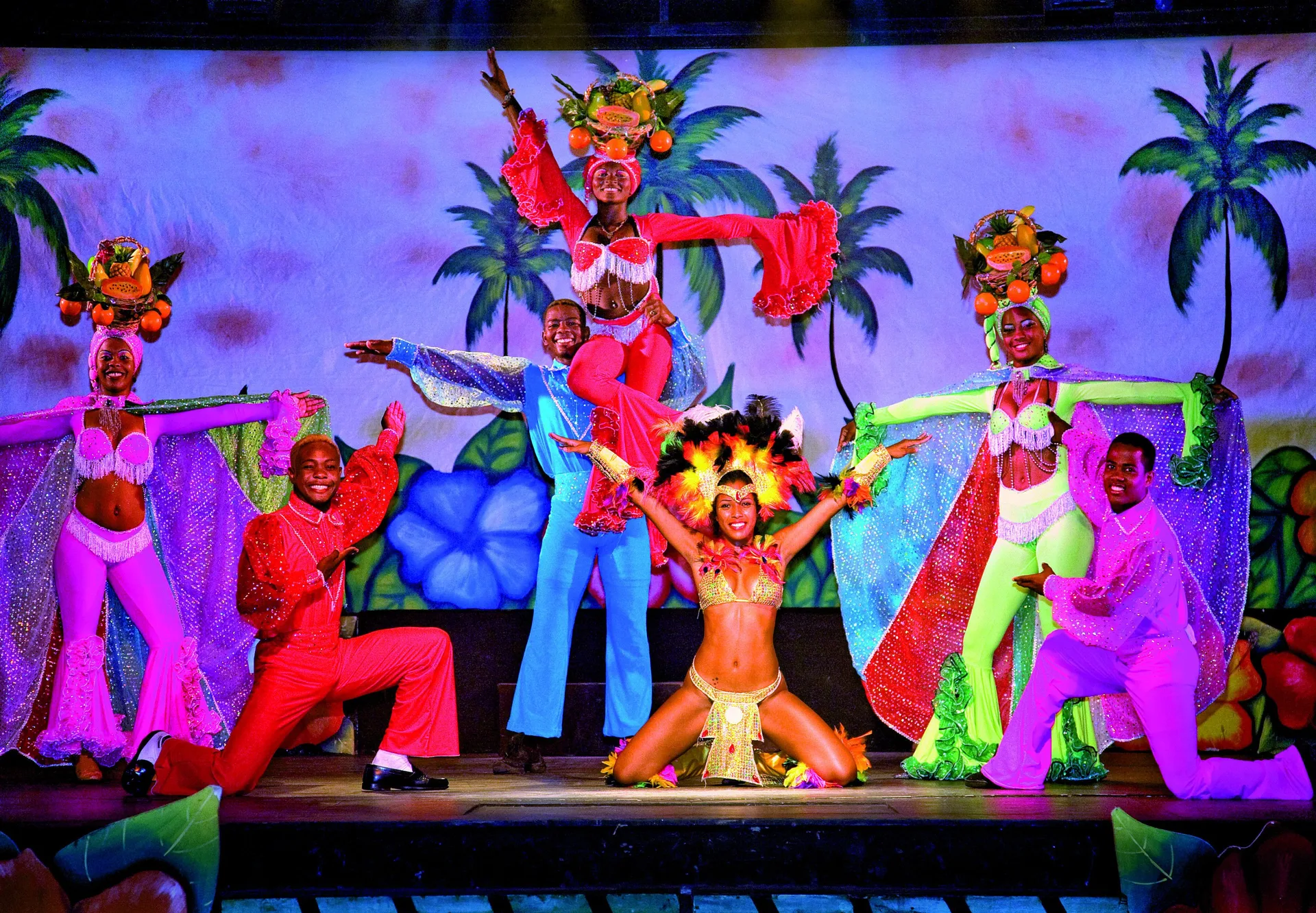 Costumed performers pose on a colorful stage at Viva Tangerine.