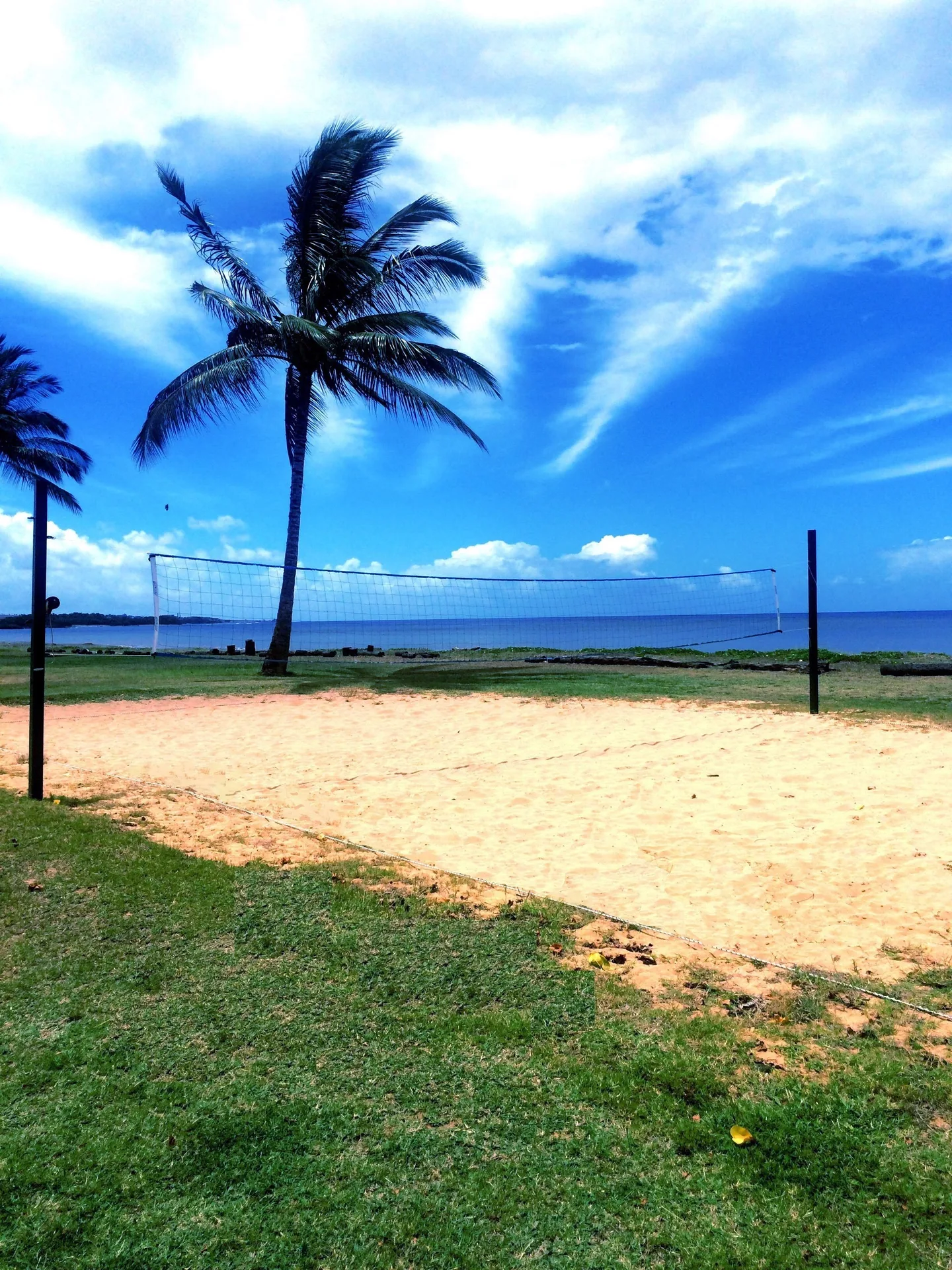 Sandy volleyball court by the ocean at Waimea Plantation Cottages.
