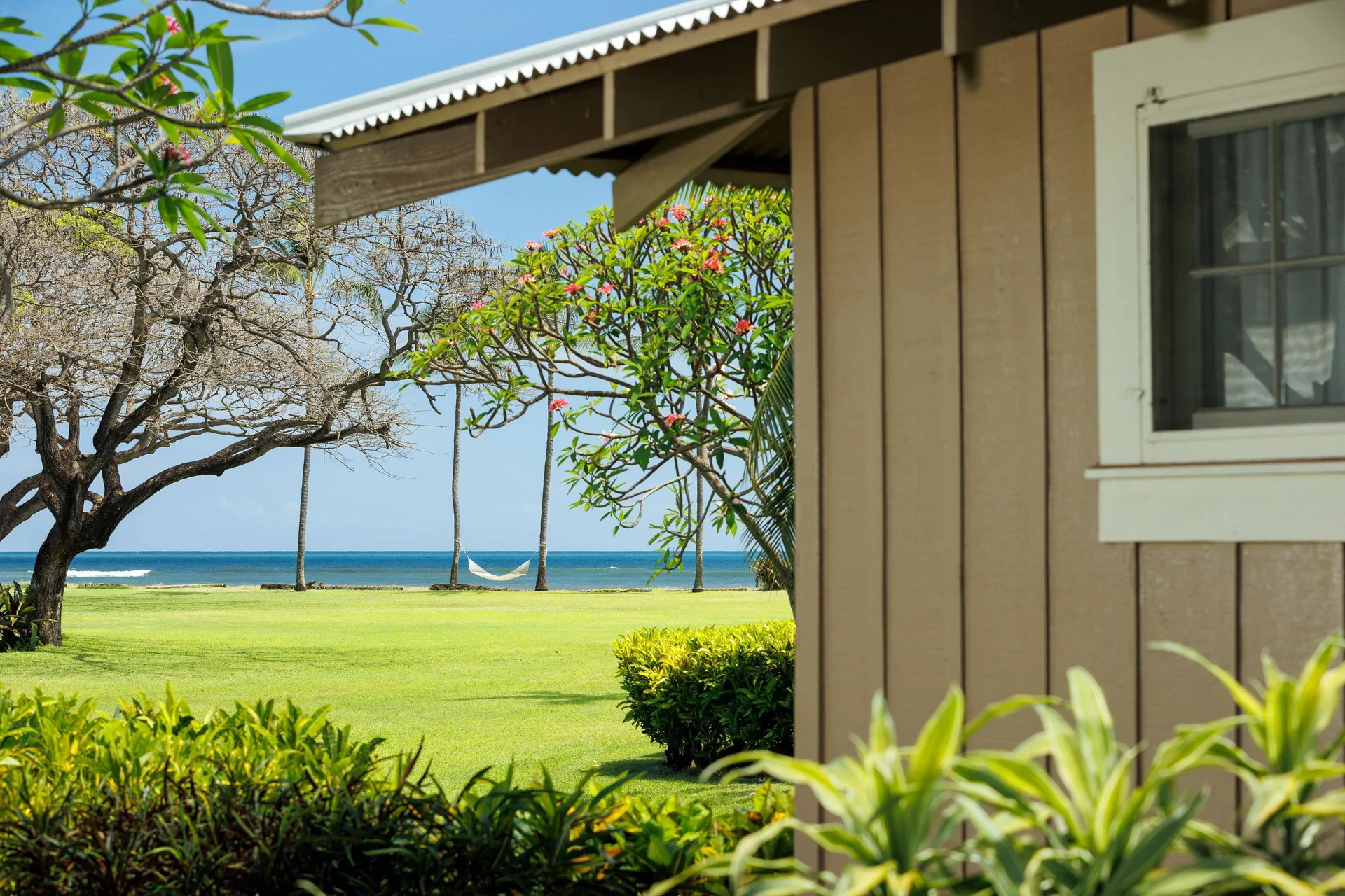 Coast Cottage ocean view across the lawn at Waimea Plantation Cottages.