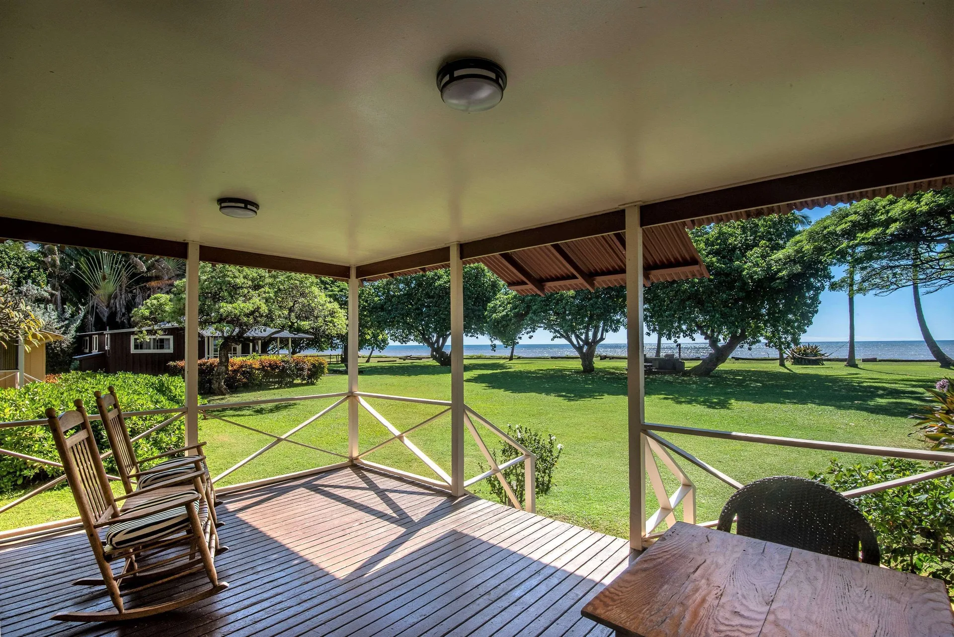 Coast Cottage porch with rocking chairs and ocean view at Waimea Plantation Cottages.